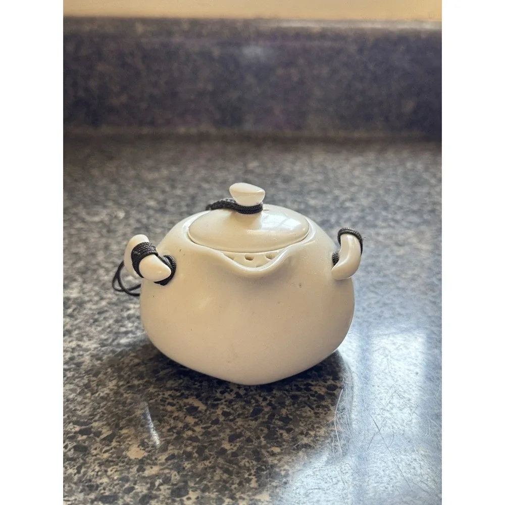 Compact travel tea pot white ceramic with decorative cord